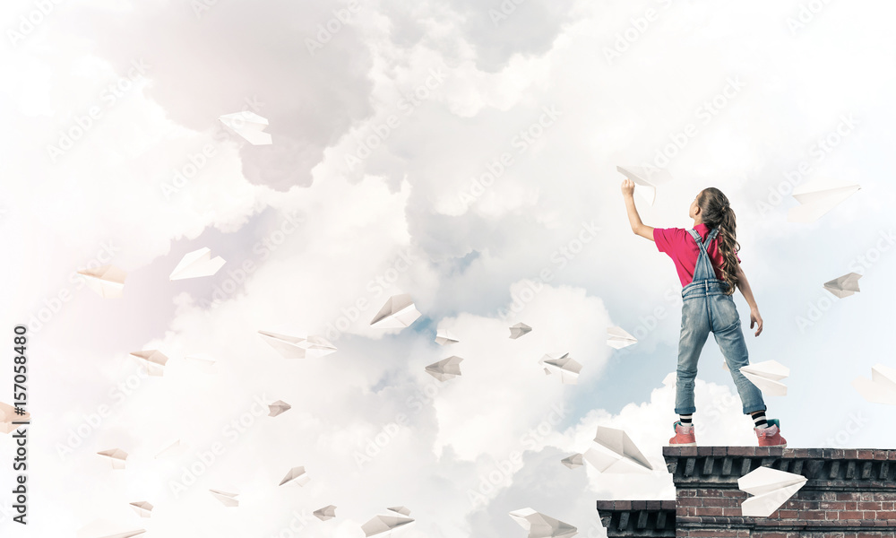 Concept of careless happy childhood with girl dreaming to become Concept of careless happy childhood with girl dreaming to become