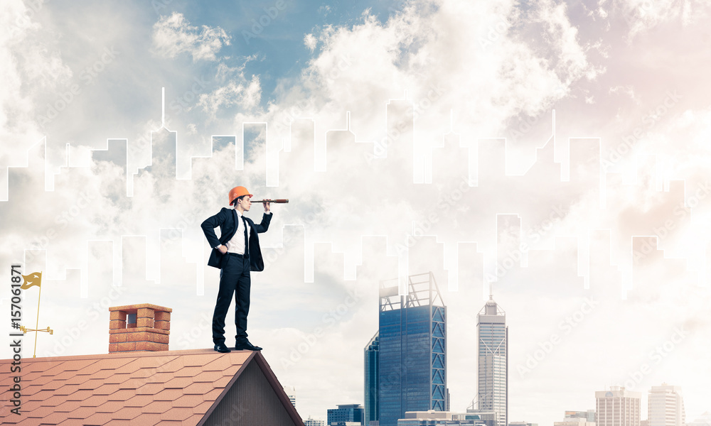Engineer man standing on roof and looking in spyglass. Mixed med Engineer man standing on roof and looking in spyglass. Mixed med