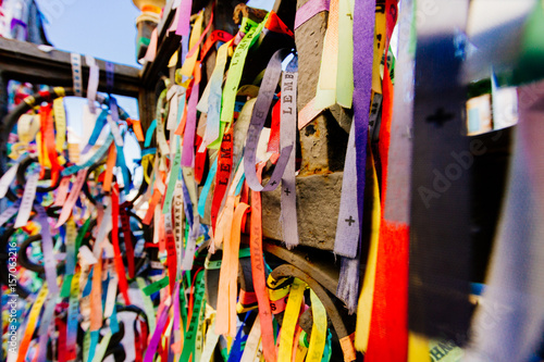 Colorful fabric ribbons (Lembranca do Senhor do Bonfim) tied in a grating in Salvador, Brazil