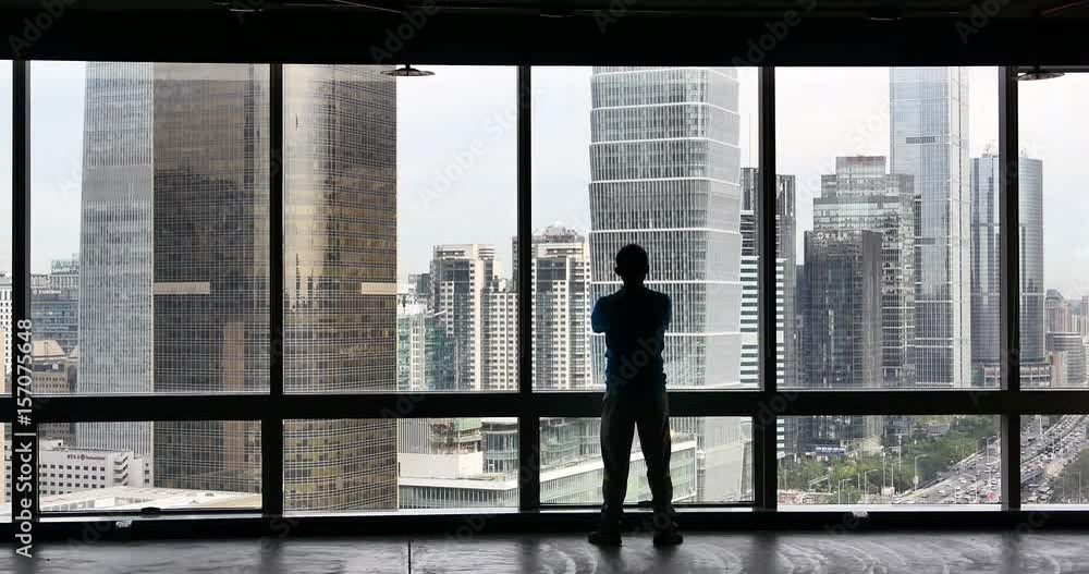 4k,businessman Overlooking the urban business building from window,skyscrapers,economic center. 4k,businessman Overlooking the urban business building from window,skyscrapers,economic center.