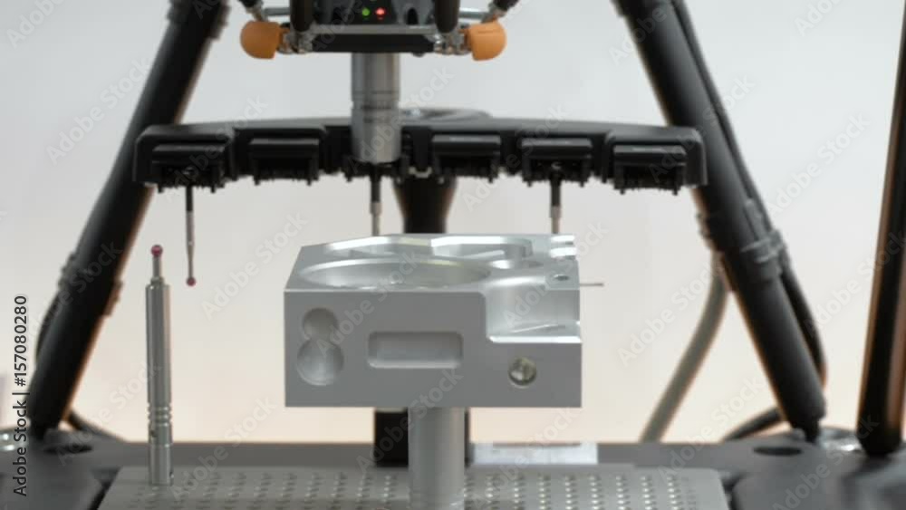 The coordinate measuring machine measures the aluminum part. The coordinate measuring machine measures the aluminum part.