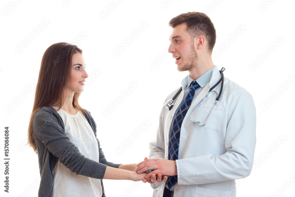 young smiling doctor lab coat holding hands sweet girl close-up young smiling doctor lab coat holding hands sweet girl close-up