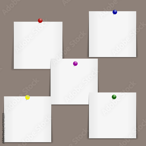 Stickers are pinned on the board. Bulletin board. A set of stickers with multicolored clerical buttons.