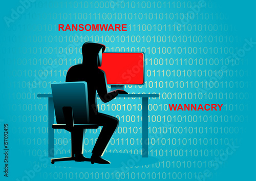 Hacker behind desktop computer