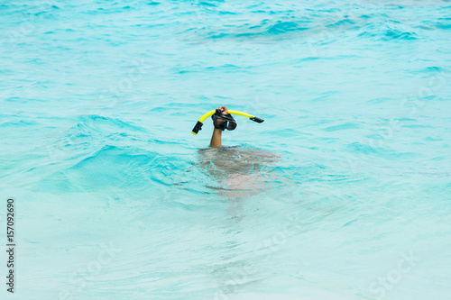Hand with a mask for snorkeling
