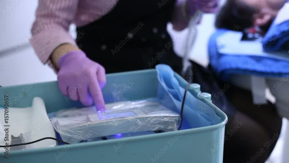 Cosmetician turn on the tool and preparing for doing permanent make-up Cosmetician turn on the tool and preparing for doing permanent make-up