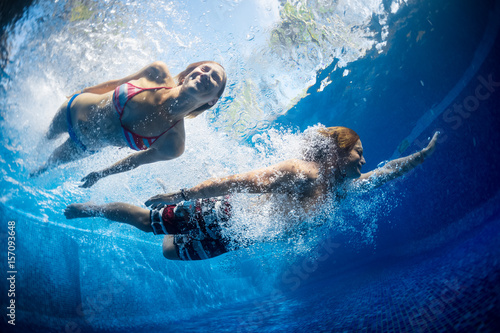 Underwater shot of the couple jumping in the pool © Dudarev Mikhail
