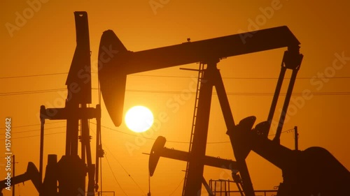 Wallpaper Mural The silhouette of oil pumps in a large oil field at sunrise. Torontodigital.ca