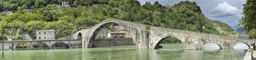 panorama with old bridge with arch's on the river in Italy