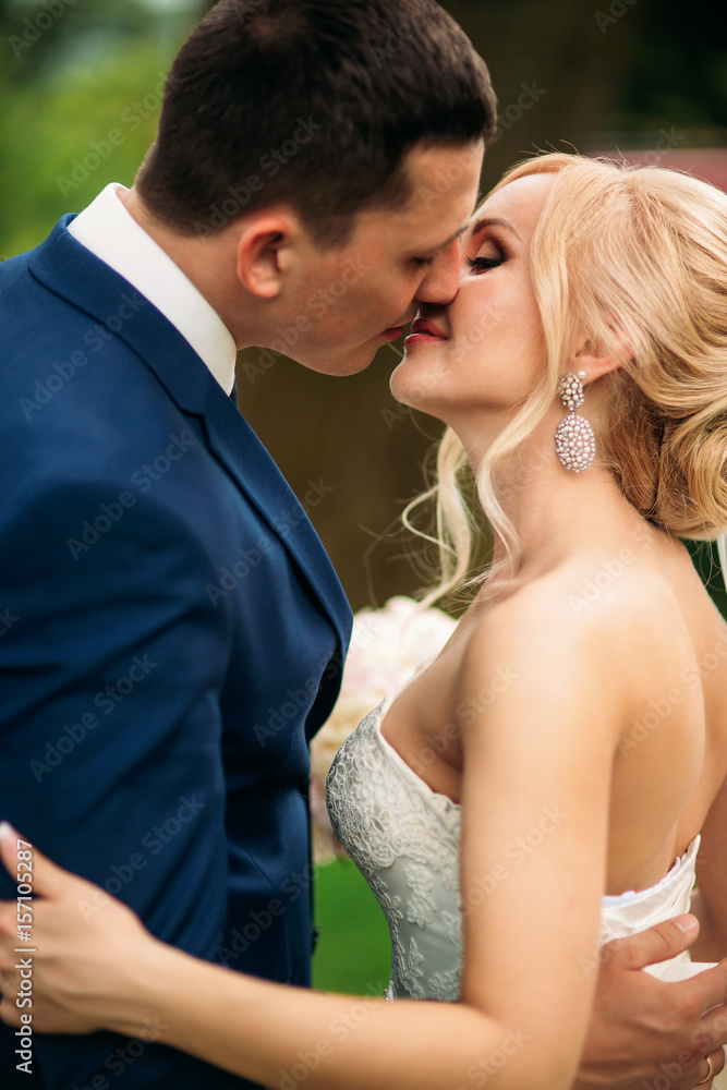 Beautiful couple walking in the park in their wedding day. Sunny weather.
Beautiful couple walking in the park in their wedding day. Sunny weather.