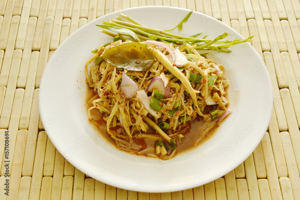 spicy shredded bamboo shoot salad in Thai northeastern style on plate spicy shredded bamboo shoot salad in Thai northeastern style on plate