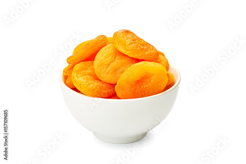 Bowl of dried apricots on white