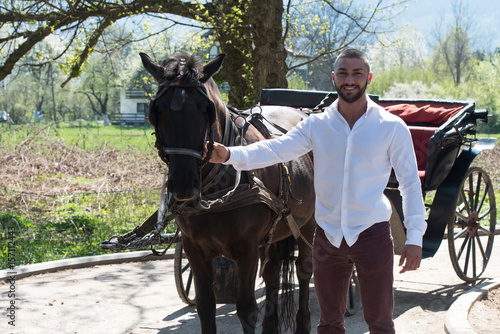 Young Man With Horse Standing in Park