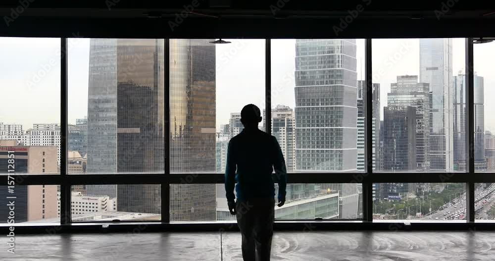 4k,4k,businessman walking to the window & Overlooking the urban business building,skyscrapers,economic center. 4k,4k,businessman walking to the window & Overlooking the urban business building,skyscrapers,economic center.