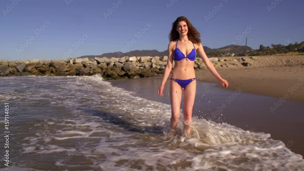 Attractive woman running on the beach. Slow Motion. Attractive woman running on the beach. Slow Motion.