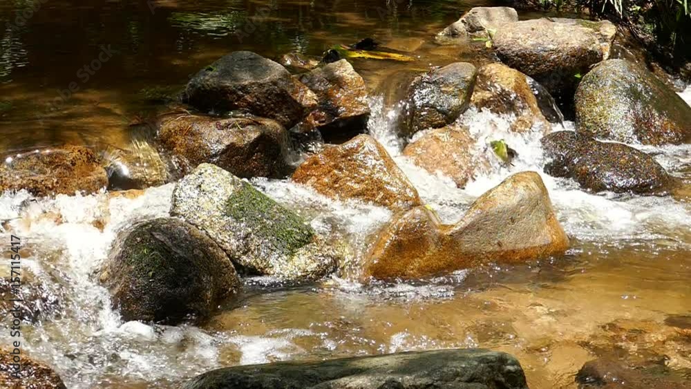 Slow motion rushing waterfall in the mountains with tropical forest. Beautiful nature background. Slow motion rushing waterfall in the mountains with tropical forest. Beautiful nature background.