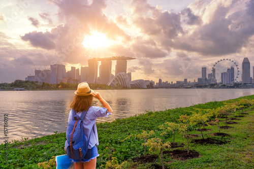 Young woman traveler  with singapore city downtown background photo