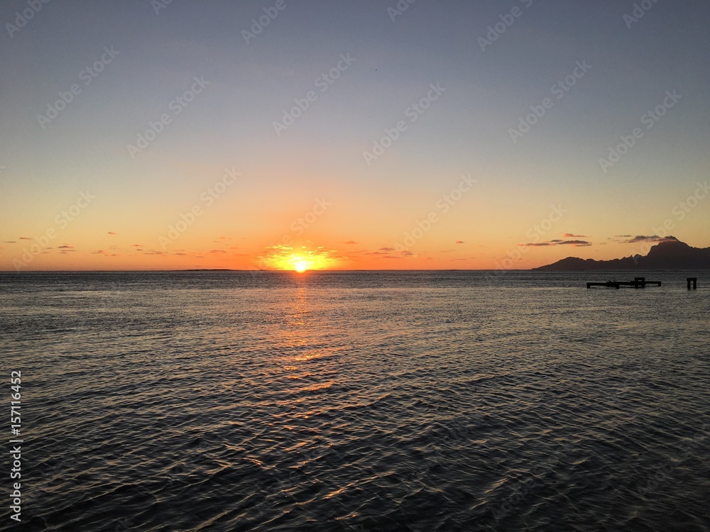 Sunset at the beach of Punaauia providing a beautiful view on Moorea, Tahiti, French Polynesia