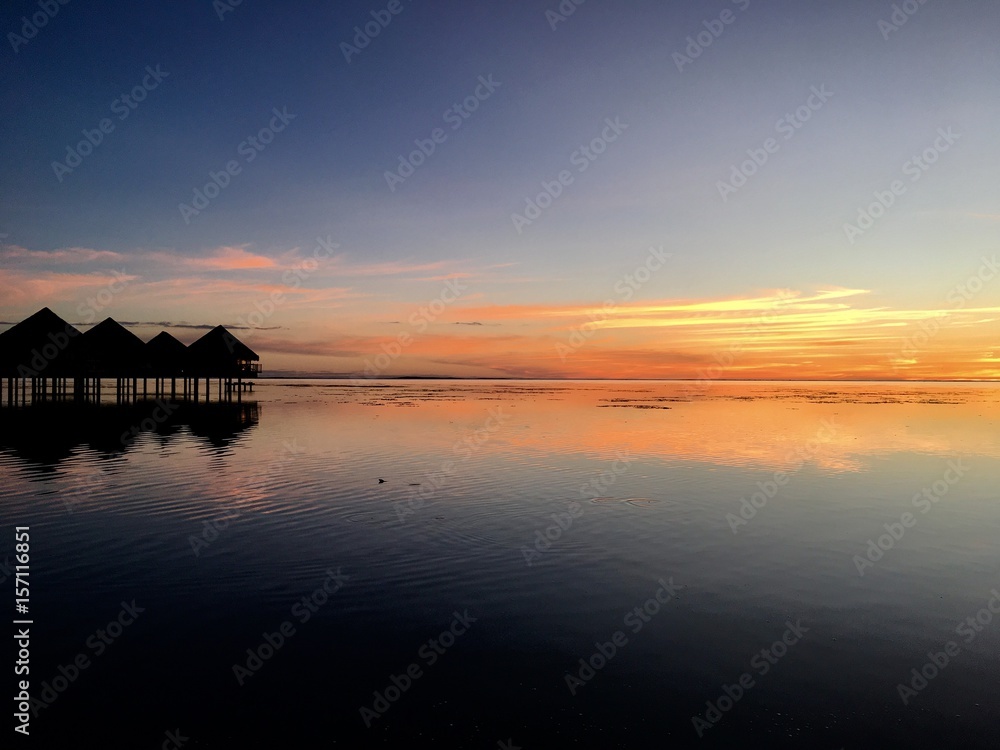Beautiful view on Moorea and the overwater bungalows of a luxury resort during sunset at the beach of Punaauia Beautiful view on Moorea and the overwater bungalows of a luxury resort during sunset at the beach of Punaauia
