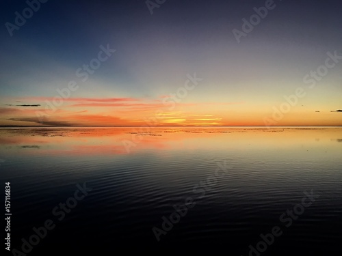 Beautiful view on Moorea and the overwater bungalows of a luxury resort during sunset at the beach of Punaauia