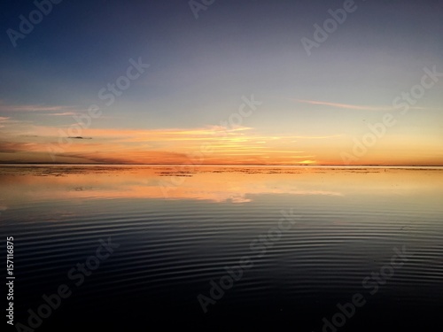 Beautiful view on Moorea and the overwater bungalows of a luxury resort during sunset at the beach of Punaauia