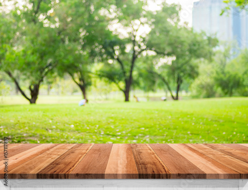 Empty brown wooden table top with blurred green fields at park, Mock up template for display or montage of your design,Banner for advertise of product © weedezign