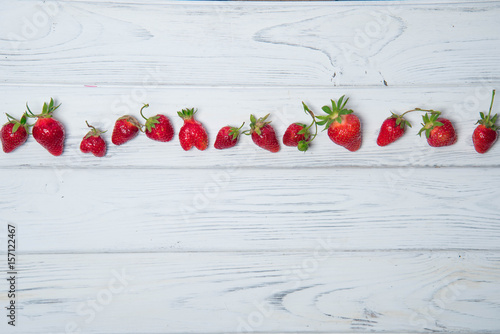 Strawberry on a white wooden background, top viewv photo