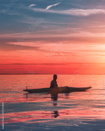 lonley kayaker girl in the sunset