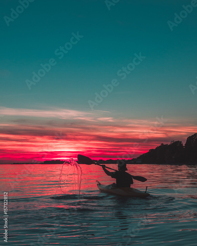 kayaking during sunset with water splash