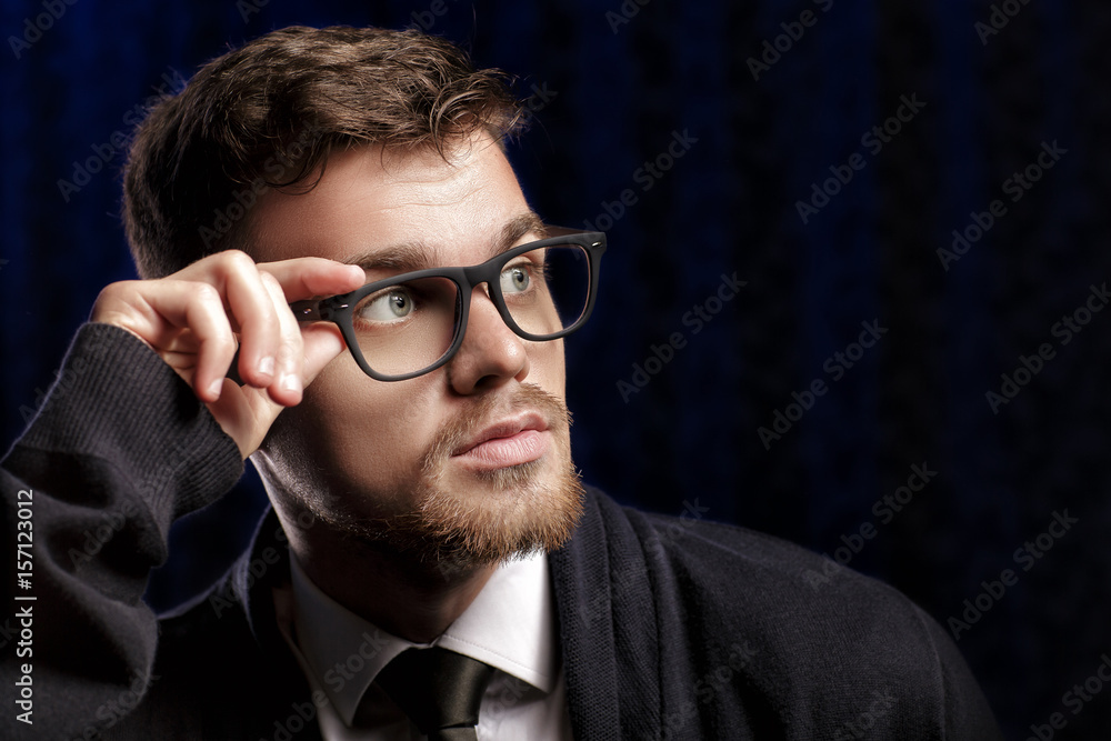 Portrait of handsome young man with glasses and white shirt on dark background Portrait of handsome young man with glasses and white shirt on dark background
