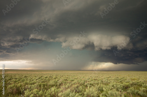 A wall cloud forms underneath the updraft of a supercell thunderstorm in eastern Colorado. photo