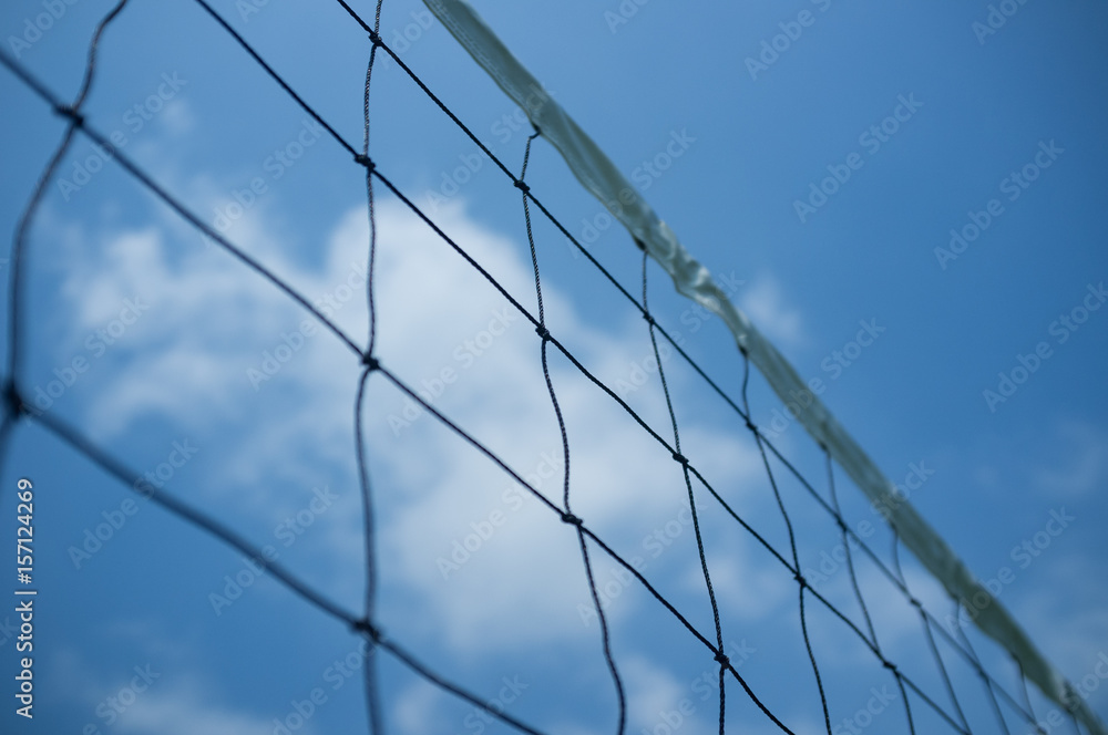 Close-up of volleyball net with blue sky background. Close-up of volleyball net with blue sky background.