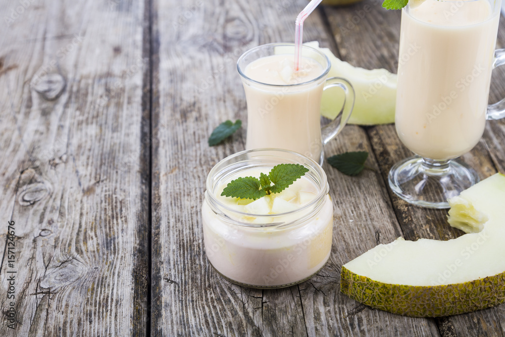 Yogurt and smoothie with melon on a wooden table. Yogurt and smoothie with melon on a wooden table.