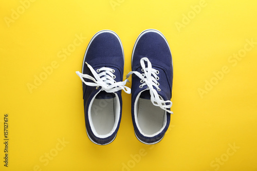 Blue sport shoes on yellow background
