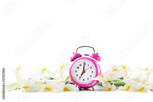 Fototapeta Naklejka Na Ścianę i Meble -  Bouquet of iris flowers with alarm clock on white background