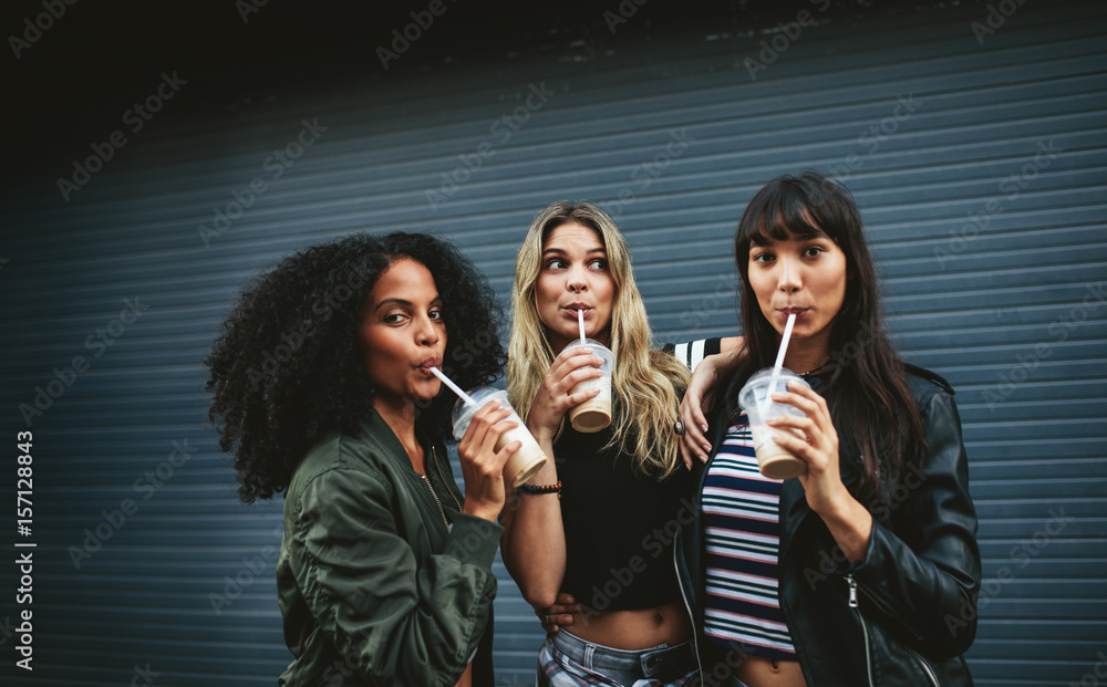 Multiracial group of women friends drinking coffee