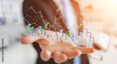 Businessman using digital 3D rendered stock exchange stats and charts