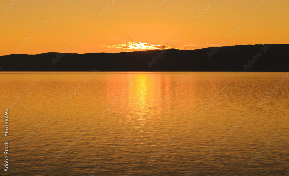 Beautiful sunset on lake Baikal in summer evening