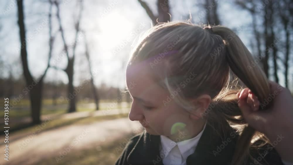 Gimbal fly around shot of female teen girl standing on town alley in spring sunny day and look up, uhd prores footage Gimbal fly around shot of female teen girl standing on town alley in spring sunny day and look up, uhd prores footage