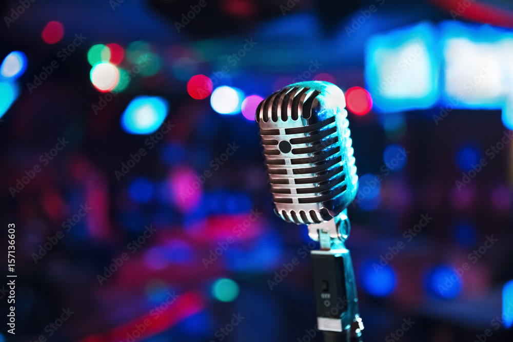 Fototapeta premium Retro microphone against blur colorful light background