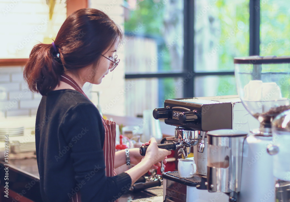 Women Barista smiling and using coffee machine in coffee shop counter - Working woman small business owner food and drink cafe concept Women Barista smiling and using coffee machine in coffee shop counter - Working woman small business owner food and drink cafe concept