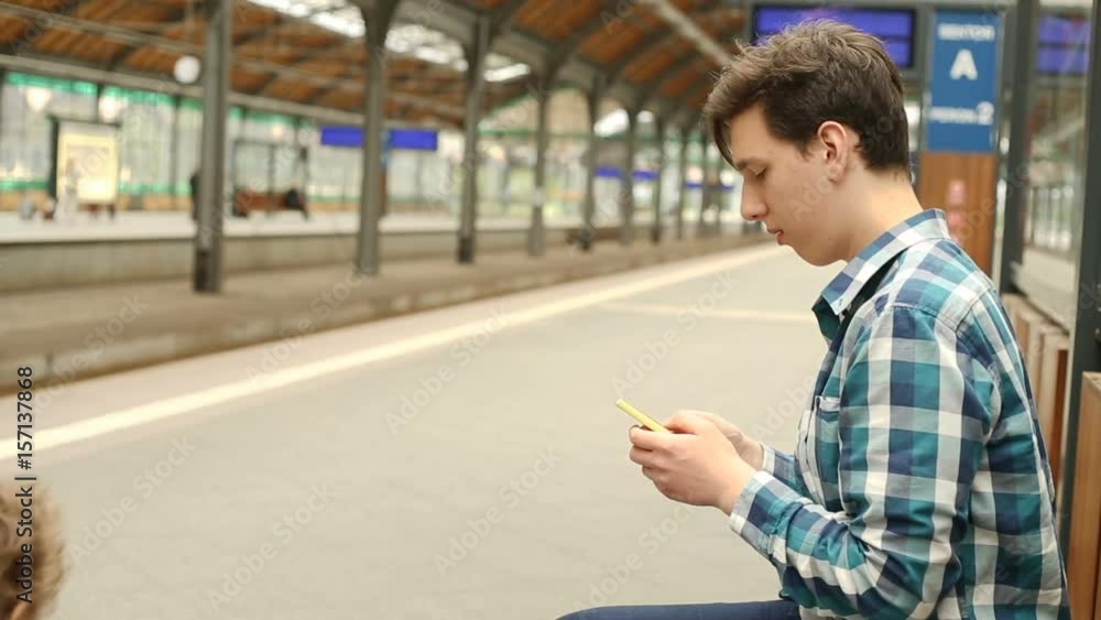 Father texting sms on smartphone while his son is walking on the platform
Father texting sms on smartphone while his son is walking on the platform