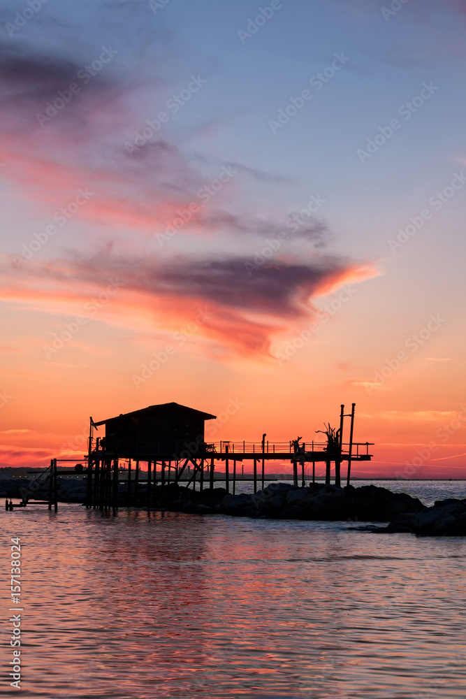 Stilt house in silhouette over the sea Stilt house in silhouette over the sea