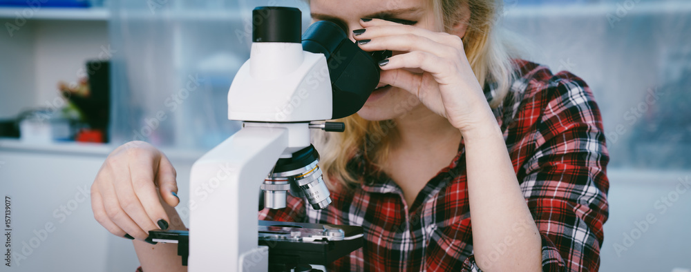 female student in biological classroom with science microscope Stock ...