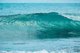 Blue ideal wave in tropical ocean. Wave barrel crashing and clear water.