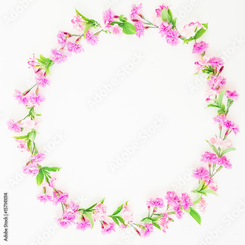 Floral round frame made of pink flowers on white background. Flat lay, top view. Floral concept © artifirsov