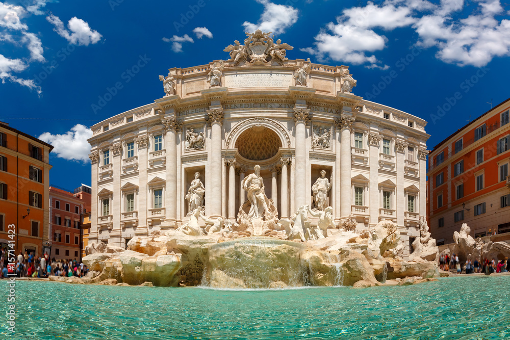 Rome Trevi Fountain or Fontana di Trevi in the sunny summer day, Rome, Italy. Trevi is the largest Baroque, most famous and visited by tourists fountain of Rome.