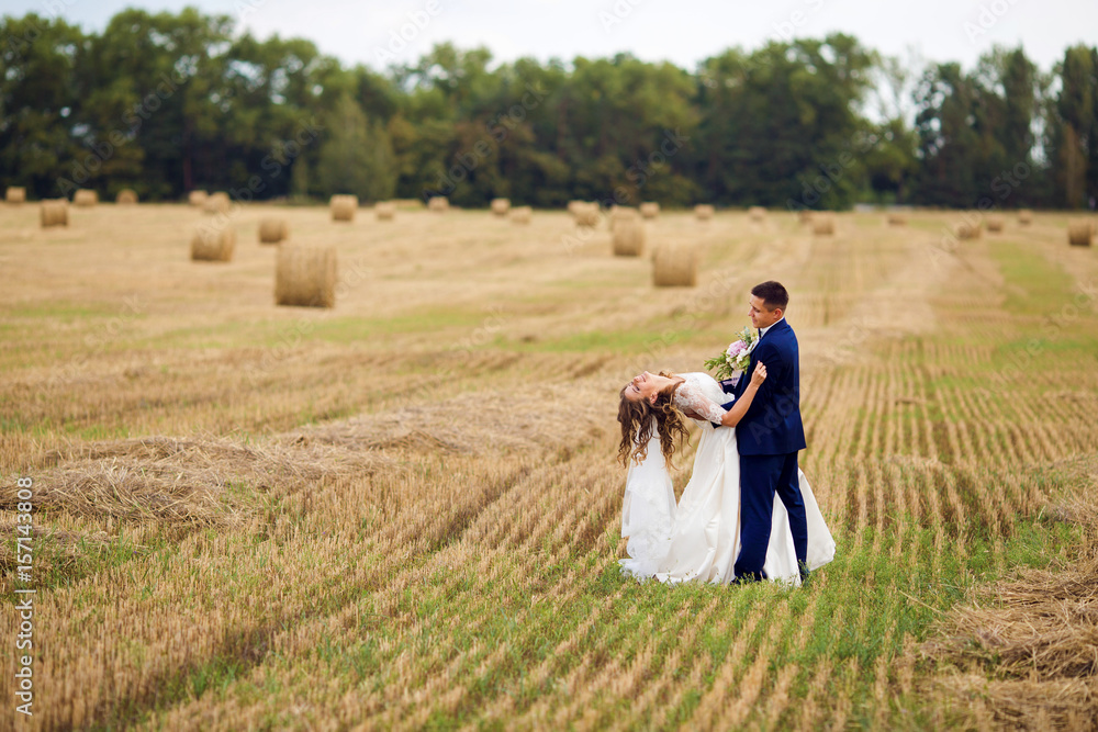 Happy newlyweds in a field Happy newlyweds in a field