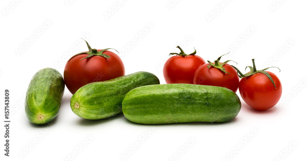 Fresh vegetables on a white background, cucumbers and tomatoes Fresh vegetables on a white background, cucumbers and tomatoes