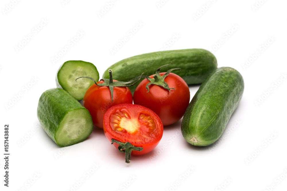 Fresh vegetables on a white background, cucumbers and tomatoes Fresh vegetables on a white background, cucumbers and tomatoes